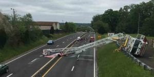 Fire truck with american flag tips, crashes into car on highway