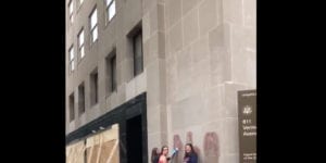 Video shows woman berating women for removing graffiti from federal building