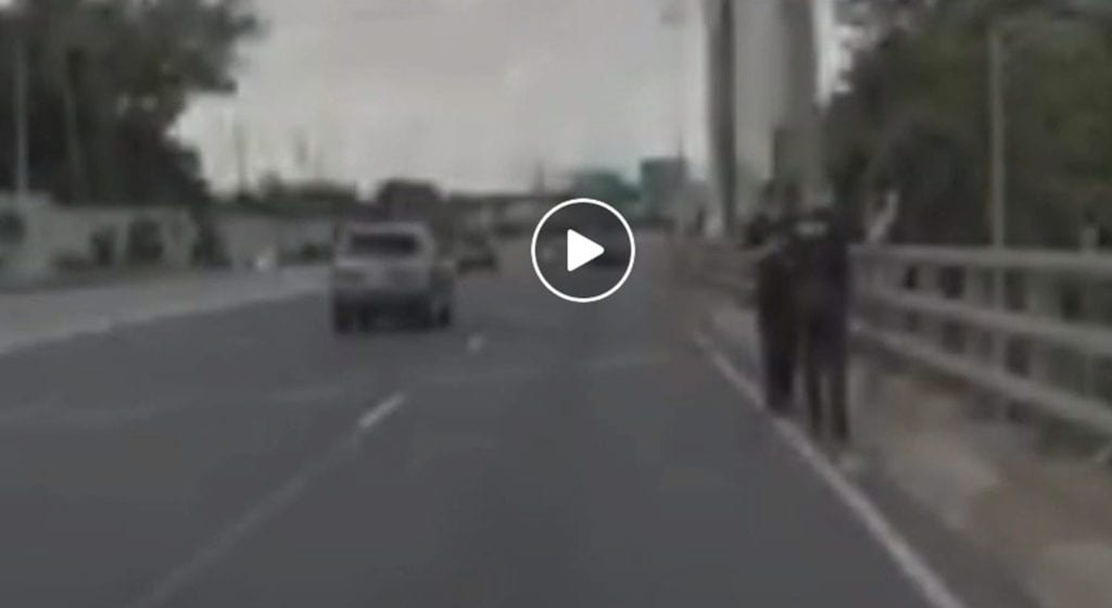 East brunswick police officers stops man from jumping off bridge - photo licensed by shore news network.