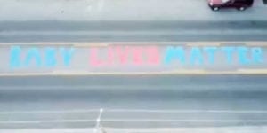 Artist paints "baby lives matter" on road in front of planned parenthood offices