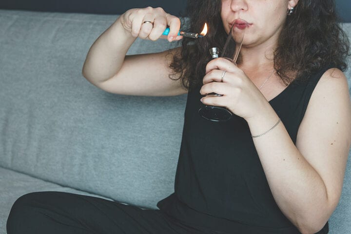 Young Person Smoking Marijuana With Bong