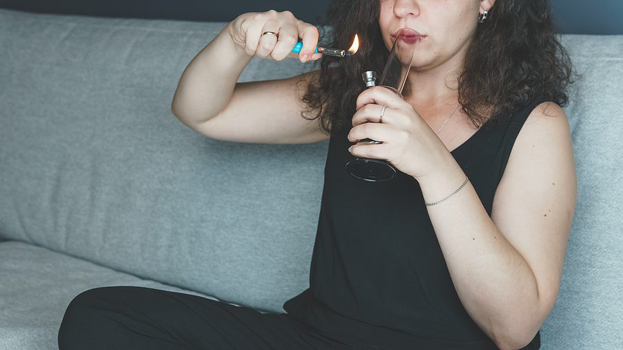 Young Person Smoking Marijuana With Bong