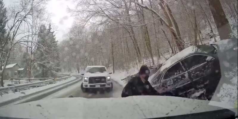 Watch: Truck slides across road, strikes parked EMT vehicle