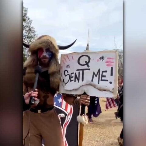 Man carrying spear, wearing furs and horned hat at capitol uprising arrested - photo licensed by shore news network.