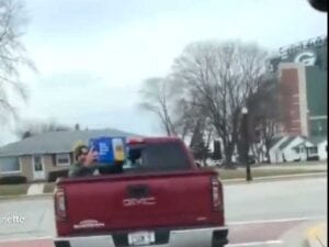 Nothing to see here except packers qb in riding in the back of a pickup with a case of beer