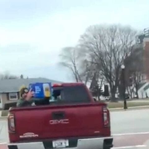 Nothing to see here except packers qb in riding in the back of a pickup with a case of beer - photo licensed by shore news network.