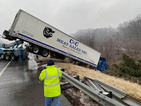 Tractor-trailer driver slid his meat into embankment while driving along icy highway