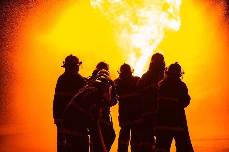 Fire fighters putting out fire - File PHoto