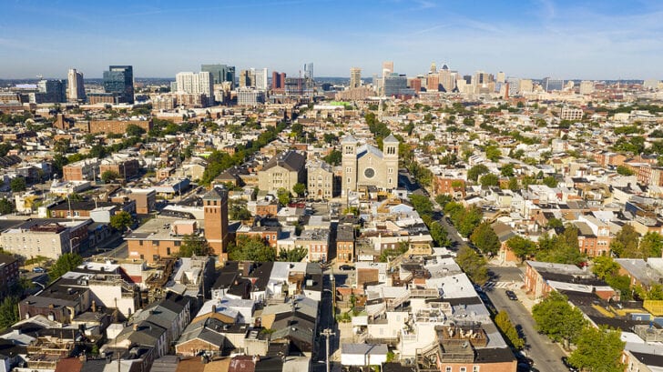 Row houses churches parks and businesses exhist in the expansive city of Baltimore