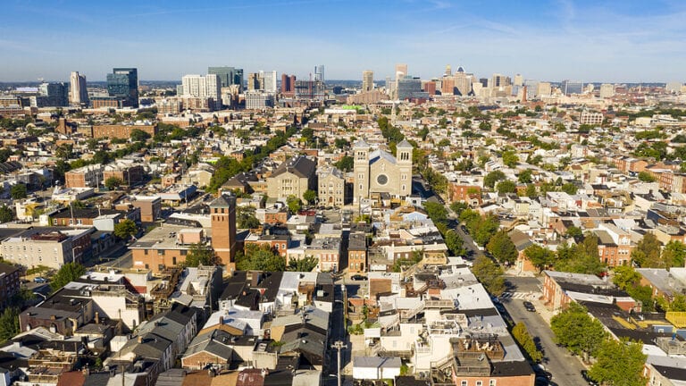 Row houses churches parks and businesses exhist in the expansive city of baltimore