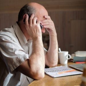 Man upset with finances/taxes - Stock Photo