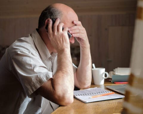 Man upset with finances/taxes - Stock Photo