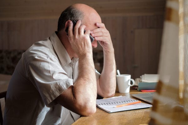 Man upset with finances/taxes - Stock Photo