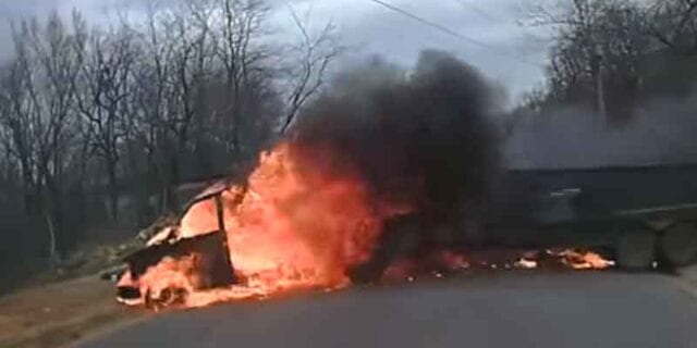 Flaming truck rolling past cop caught on dashcam