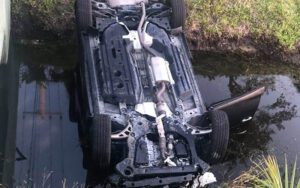 Indian river county deputy rescues woman from overturned car in canal