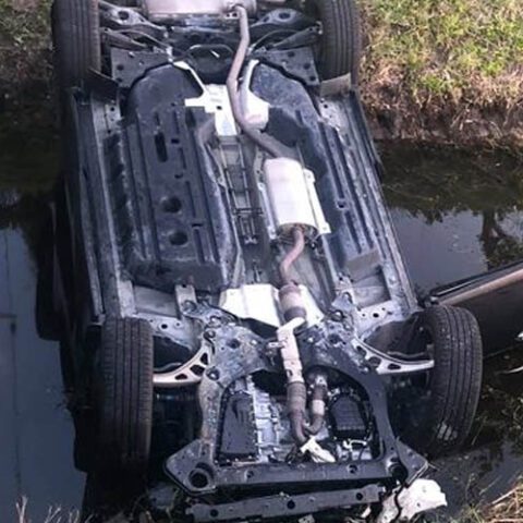 Indian river county deputy rescues woman from overturned car in canal - photo licensed by shore news network.