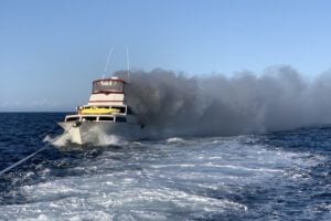 Three rescued from burning boat by Coast Guard