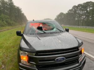 Lightning strike on highway caused chunk of road to smash through truck window