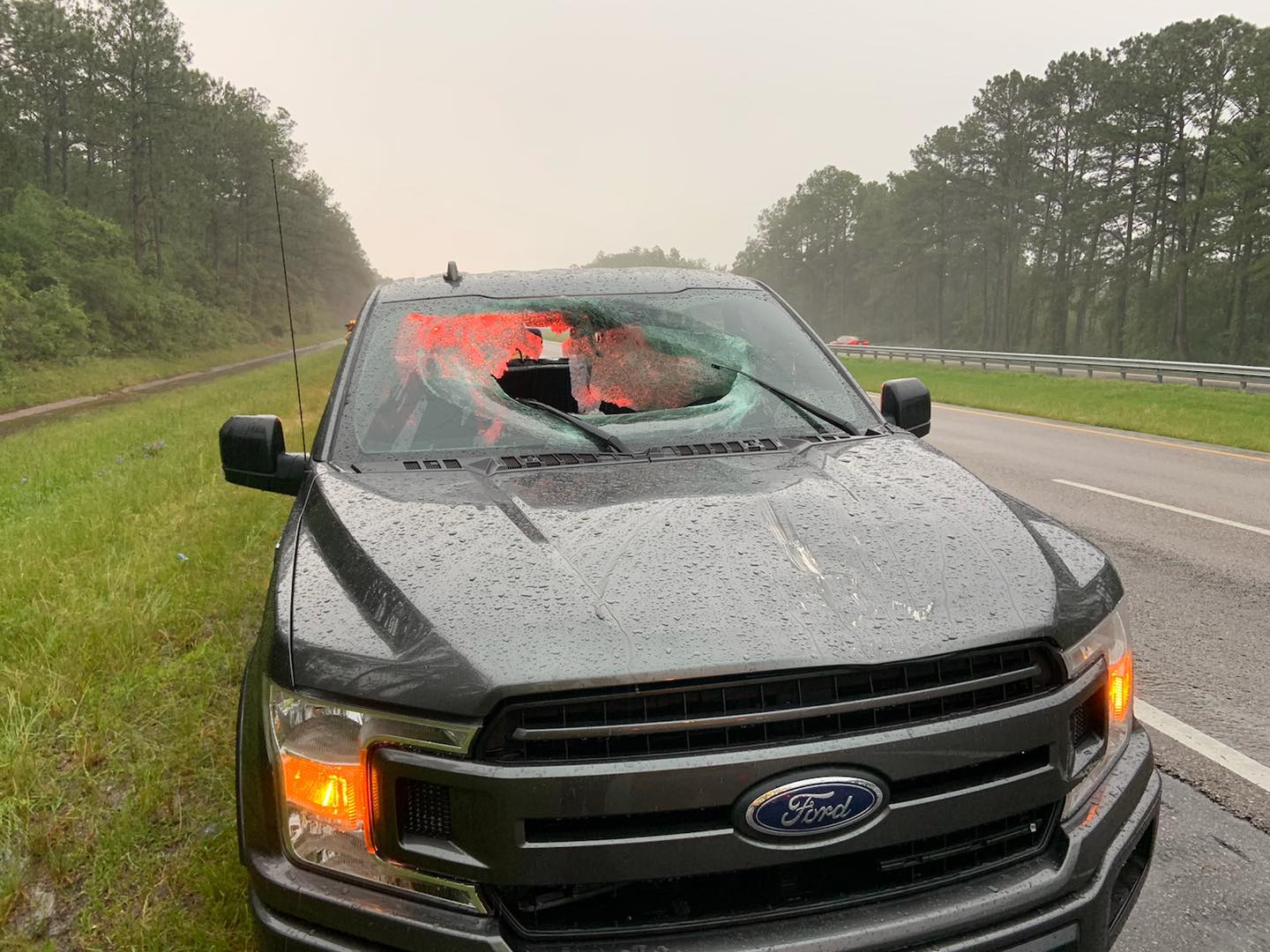 Lightning strike on highway caused chunk of road to smash through truck window