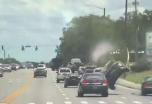 Police detectives car flips after driver runs red light