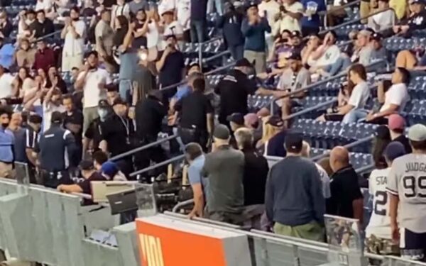 The new america: yankee fans handcuffed, escorted out of stadium for "trump won" banner | photo licensed by shore news network. The new america: yankee fans handcuffed, escorted out of stadium for "trump won" banner - photo licensed by shore news network.