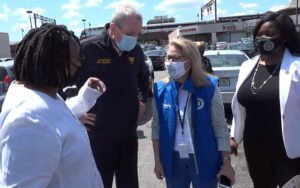 Masked up murphy greets crowd with "mask up" signs day after cdc drops mask mandate for the vaccinated