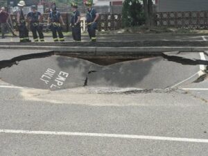 Car nearly swallowed by a massive sinkhole near route 35 in wall