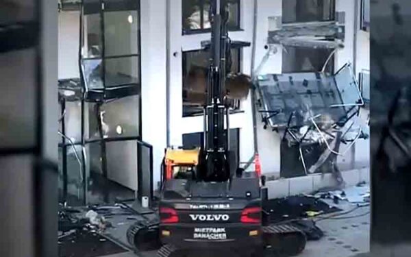 Unpaid german contractor gets revenge taking excavator to damage building - photo licensed by shore news network.