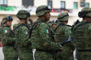 Mexican troops in riot gear attempting to stop immigrants heading to u. S.
