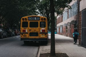 New york, usa - may 30, 2018: yellow school bus parked on a side of the road in new york.