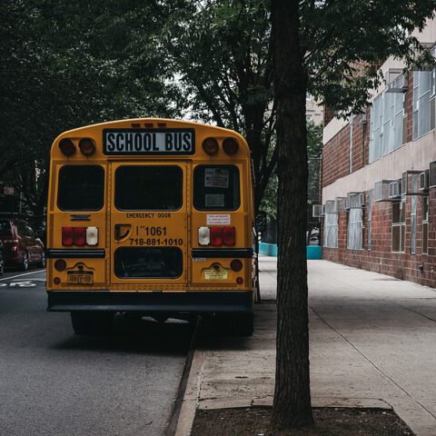 New york, usa - may 30, 2018: yellow school bus parked on a side of the road in new york.