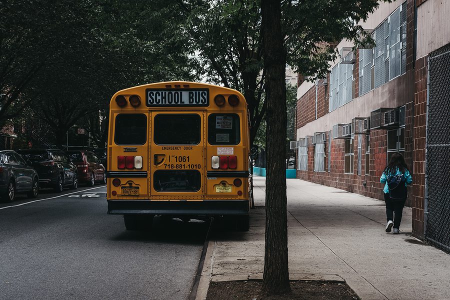 New York, USA - May 30, 2018: Yellow school bus parked on a side of the road in New York.