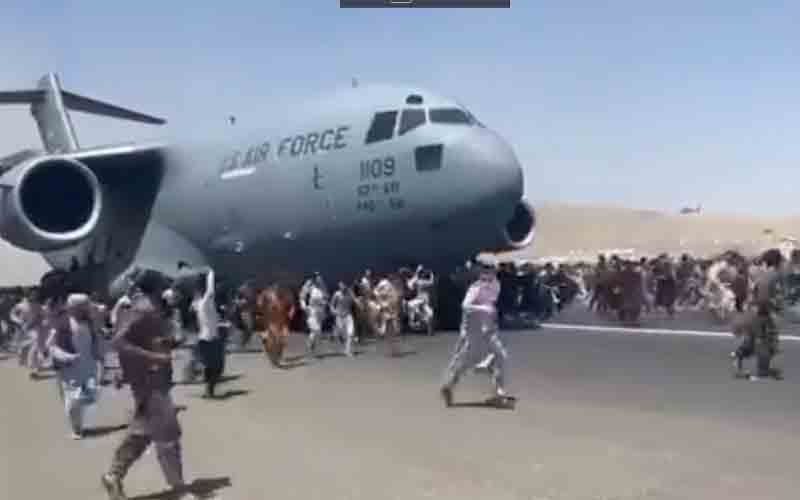Hundreds of people hang on to U.S. transport plane as it tries to leave Kabul Airport