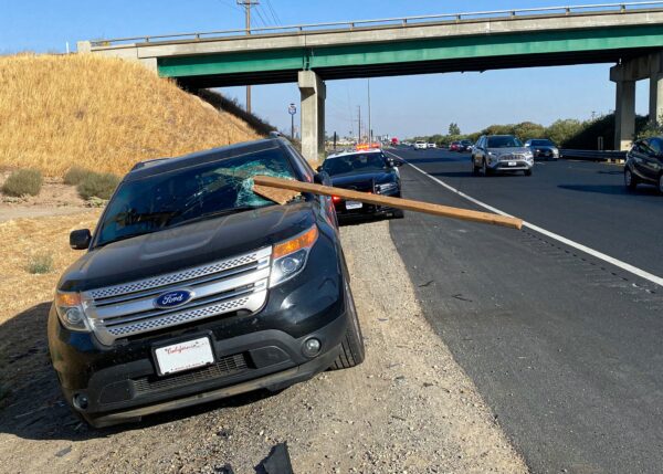 Ford explorer impaled by 2x4 while driving along route 99 - photo licensed by shore news network.