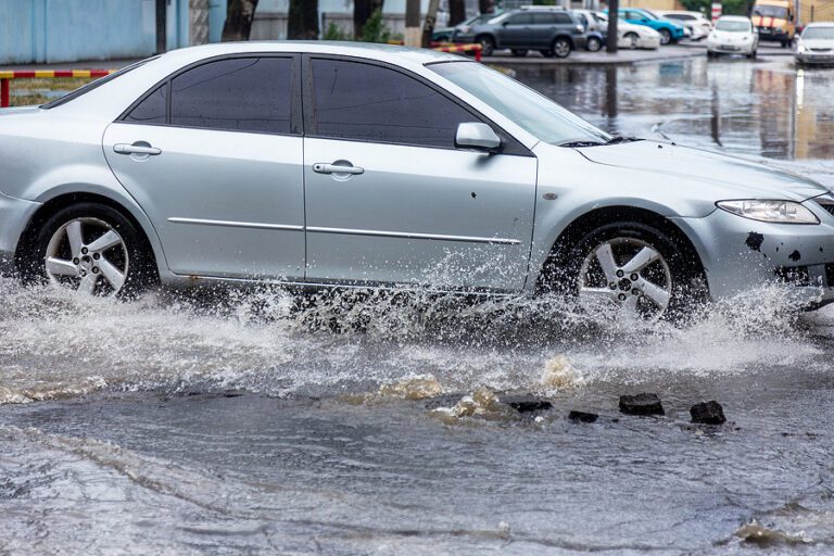 Car driving through flooded road.