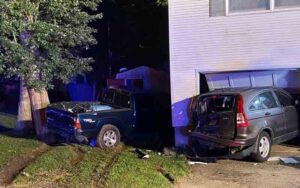 Crash sends two cars into manchester home