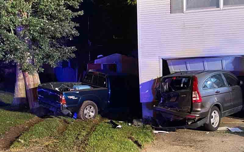 Crash sends two cars into manchester home