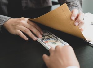 Four former employees of utility company plead guilty in bribery and kickback scheme