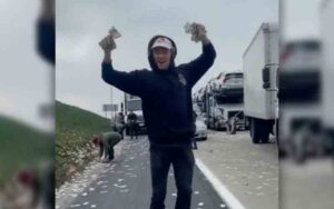 Freeway littered after money flies out of bags from armored truck