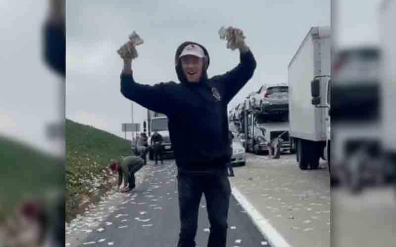 Freeway littered after money flies out of bags from armored truck