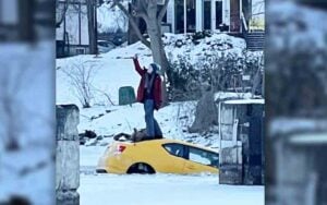 Woman Stands On Top Of Car To Take Selfie After Driving It Into Frozen River Woman Stands On Top Of Car To Take Selfie After Driving It Into Frozen River
