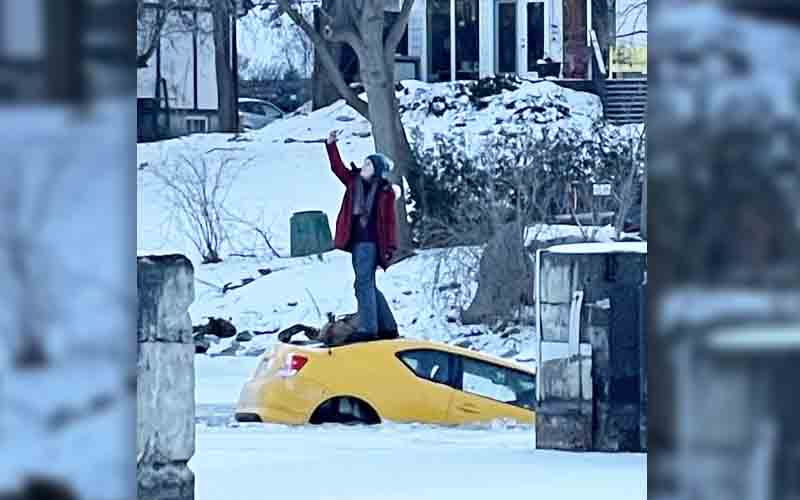 Woman Stands On Top Of Car To Take Selfie After Driving It Into Frozen River