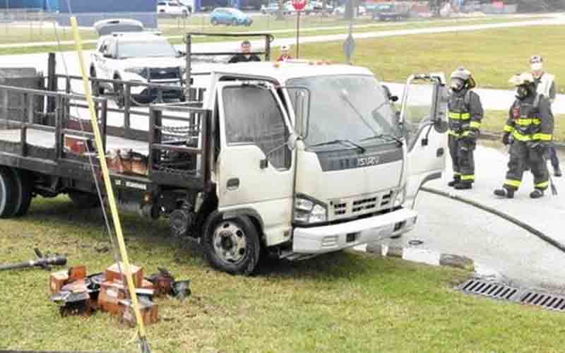 Tossed cigarette from passing vehicle torches nearby truck