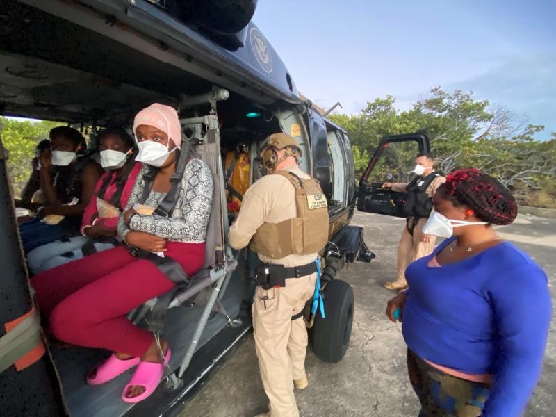 Migrants are boarded on an CAMB Blackhawk helicopter in Desecheo 