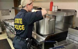 Police officers join millsville elks club to feed the community