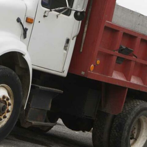 Driver injured after dump truck full of sand overturned in egg harbor - photo licensed by shore news network.