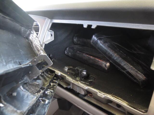 Not So Trusted Traveler Attempts to Smuggle Cocaine Through SENTRI Lane Cocaine bundles in compartment.
