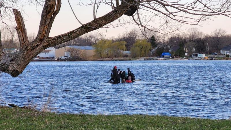 A sinking boat with 7 people on board. 