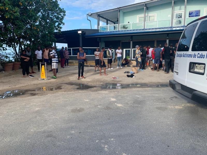 A group of haitians gathered in front of a business in Combate Beach Cabo Rojo PR