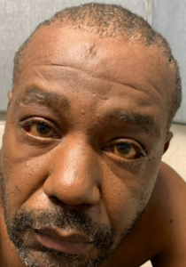 Fugitive murder suspect threatened police officers with shotgun while being served with warrant